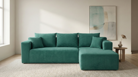 Teal sectional sofa in a living room with abstract art on the wall.